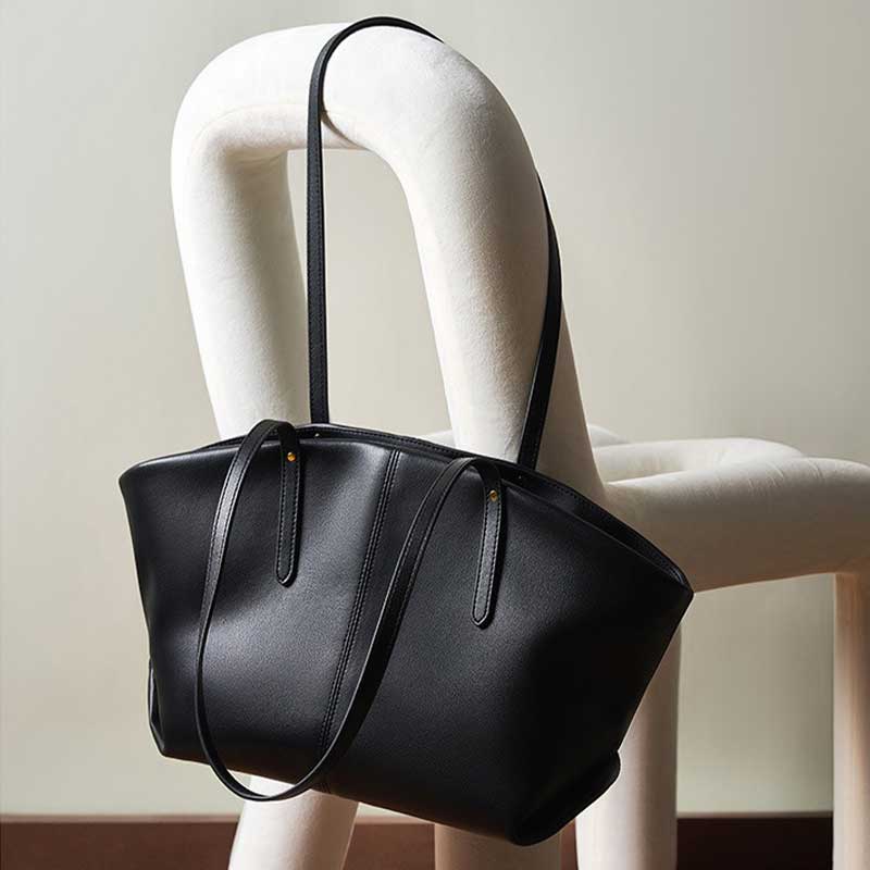 Black leather handbag on a mannequin