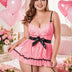 Woman wearing a Coral lace nightgown with black accents in a decorated room with balloons and flowers.