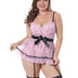 Woman wearing a pink lace babydoll with black accents on a white background