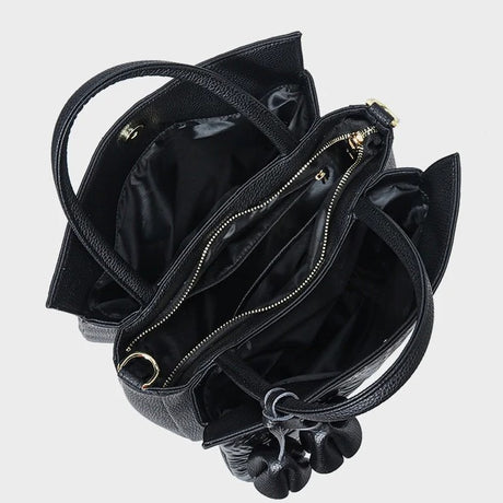 Black handbag with open top and visible interior 