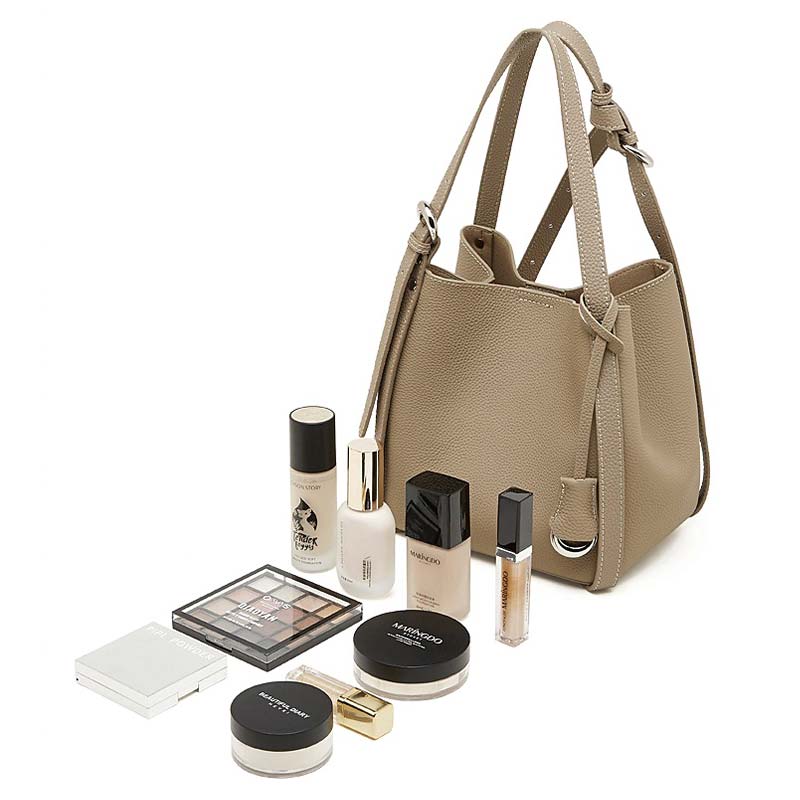 gray handbag with makeup products 