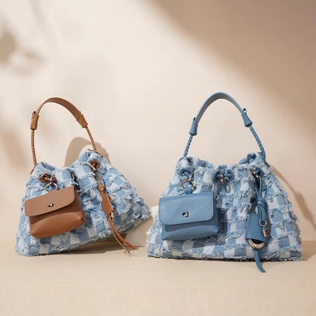 Two blue floral-patterned handbags with brown accents 