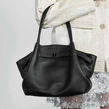 Black Genuine Leather handbag held by a person 