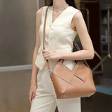 Woman holding a khaki Genuine leather handbag 