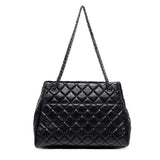 Black quilted handbag with a chain strap back view