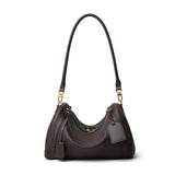 Black handbag with gold accents on a white background