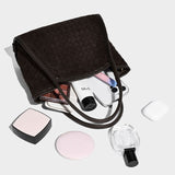 coffee textured handbag with makeup items 