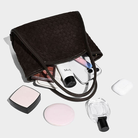 coffee textured handbag with makeup items 